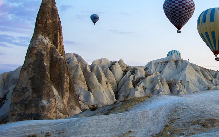 Fairy chimneys and balloons over Cappadocia at dawn